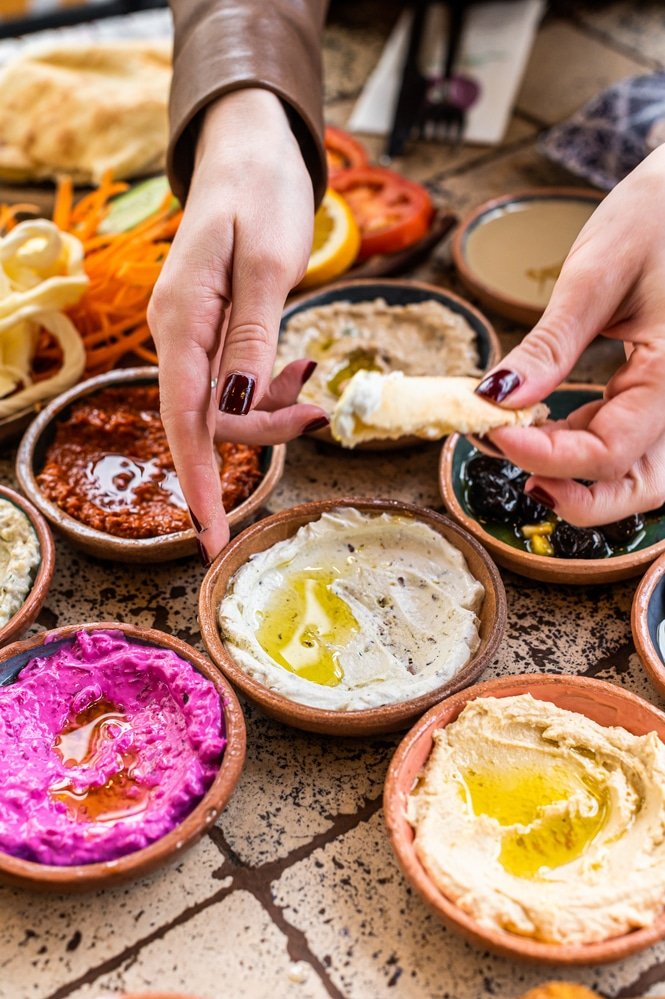 Women eating Traditional Turkish Village Breakfast served in restaurant. Meze