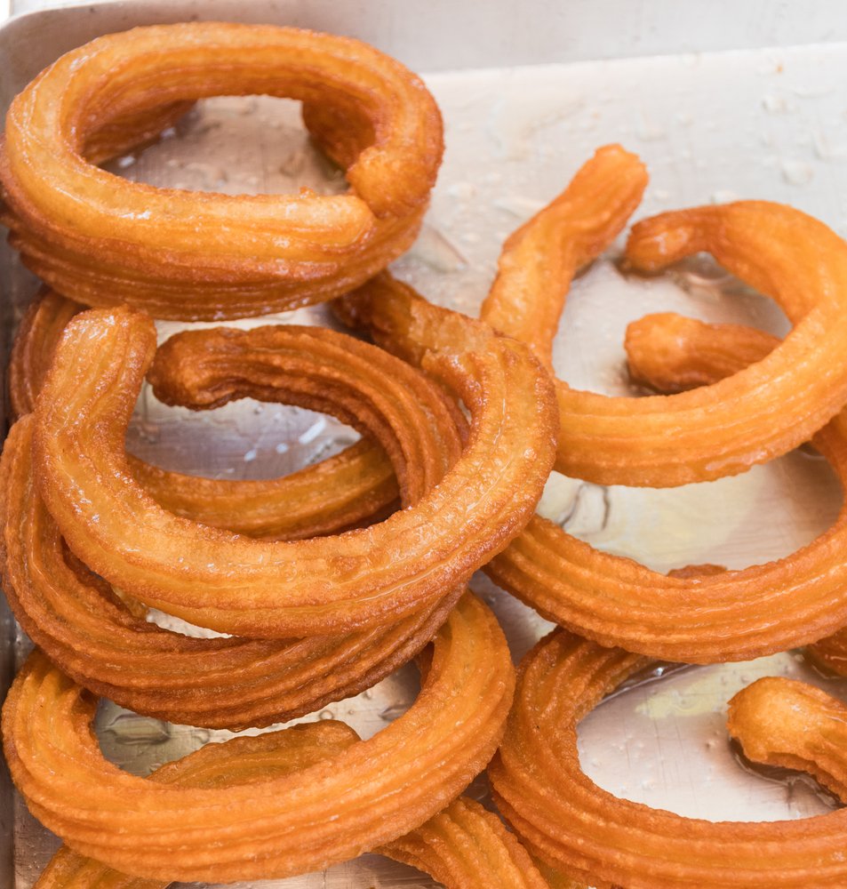 A tray of Halka Tatlısı, a popular Turkish dessert, on a table.