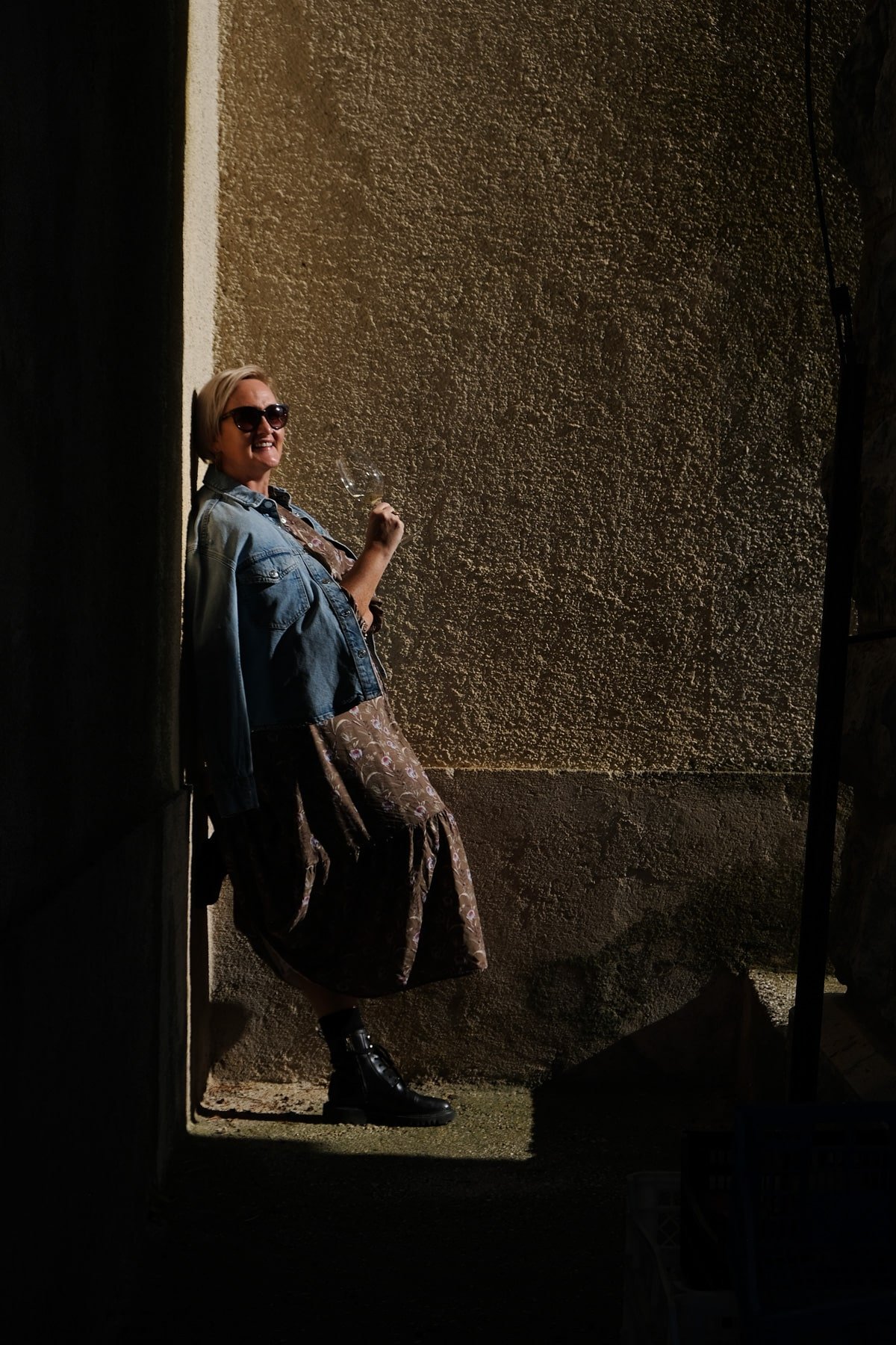 SJ leaning against a wall in Istria at a winery in Croatia. 