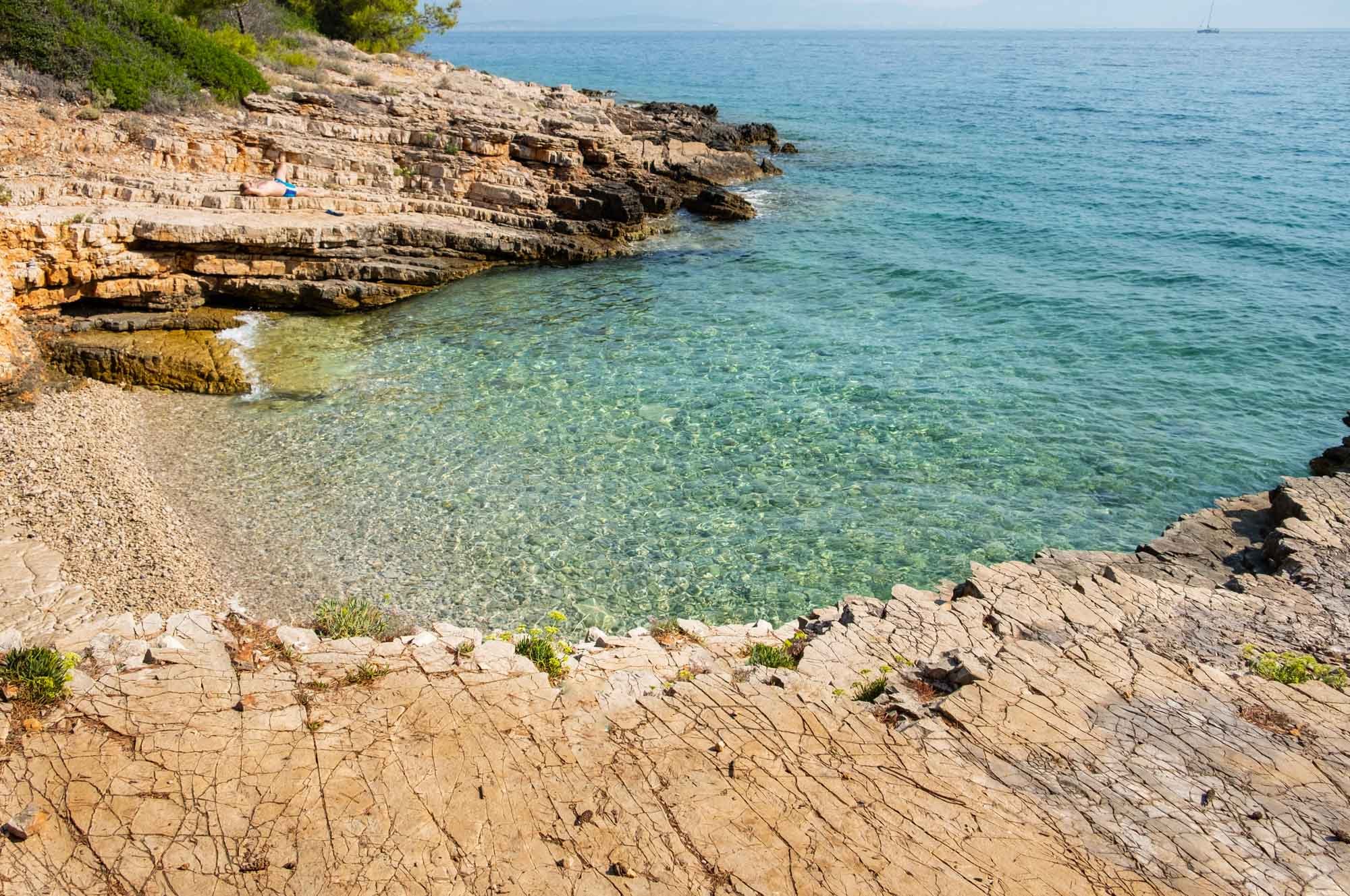 A beach on Solta Island with a rocky shore and water.