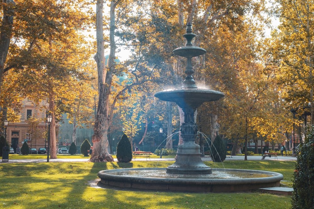 An ornate fountain amidst golden autumn foliage in a Zrinjevac Park - a top setting in Zagreb.